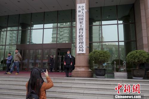 3月14日,民众在国家工商行政管理总局正门拍照。《国务院机构改革方案》13日提请十三届全国人大一次会议审议。方案提出,组建国家市场监督管理总局,不再保留国家工商行政管理总局、国家质量监督检验检疫总局、国家食品药品监督管理总局。<a target='_blank' href='http://www.chinanews.com/'>中新社</a>记者 贾天勇 摄 点击进入下一页